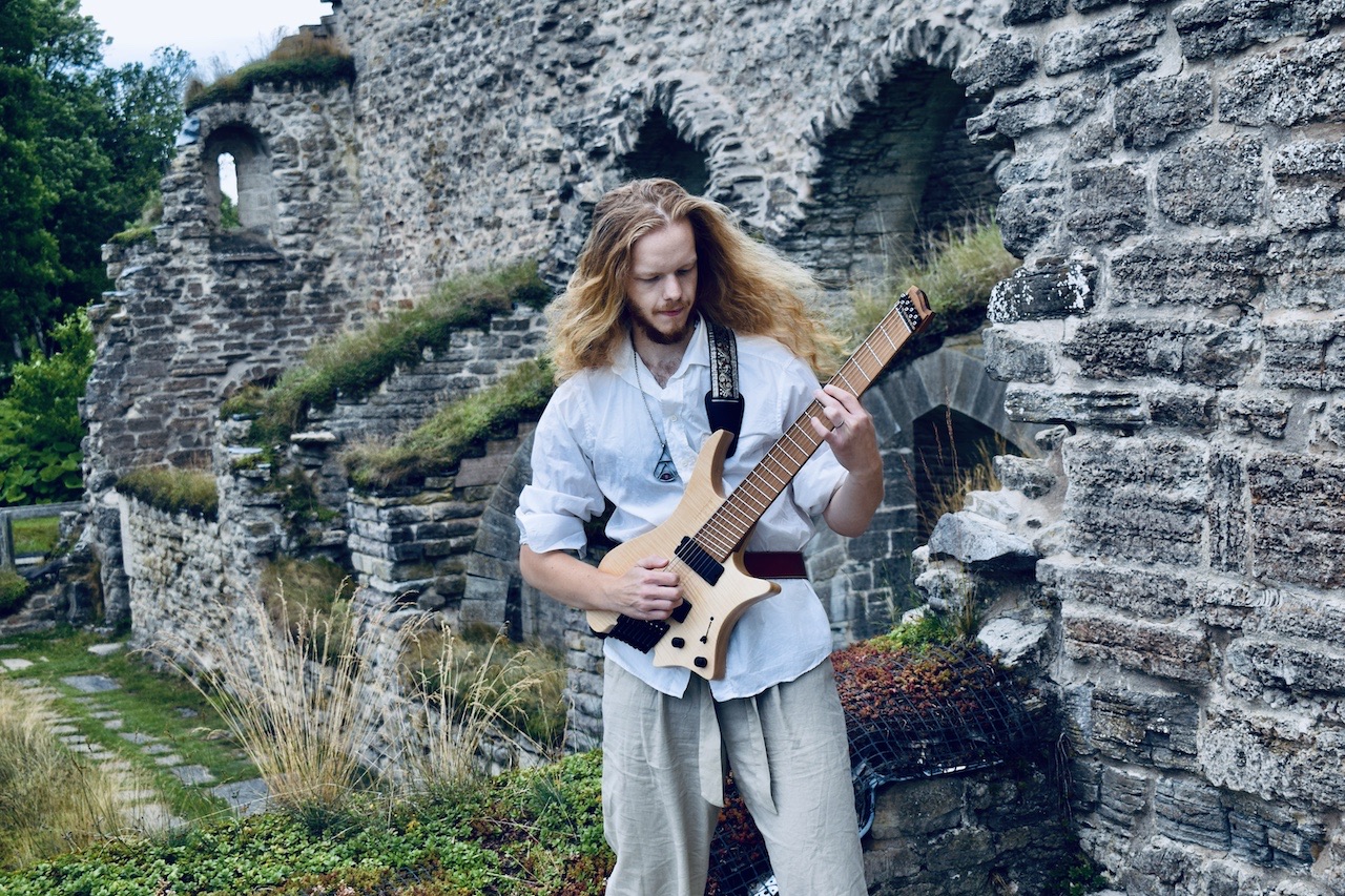 Guitarist playing in an overgrown ruin