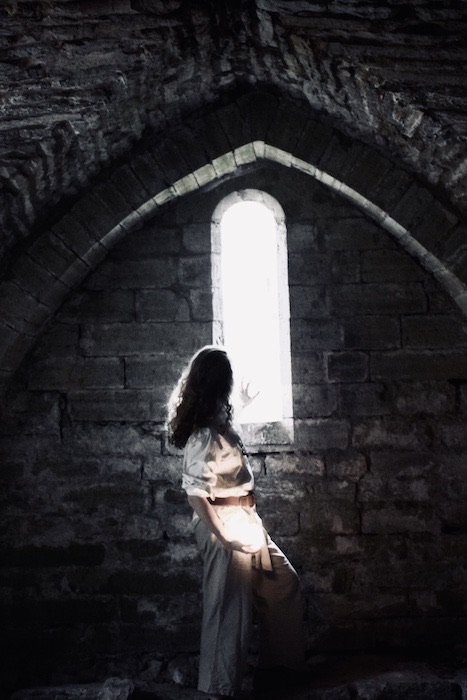 A man reaching towards a shining window