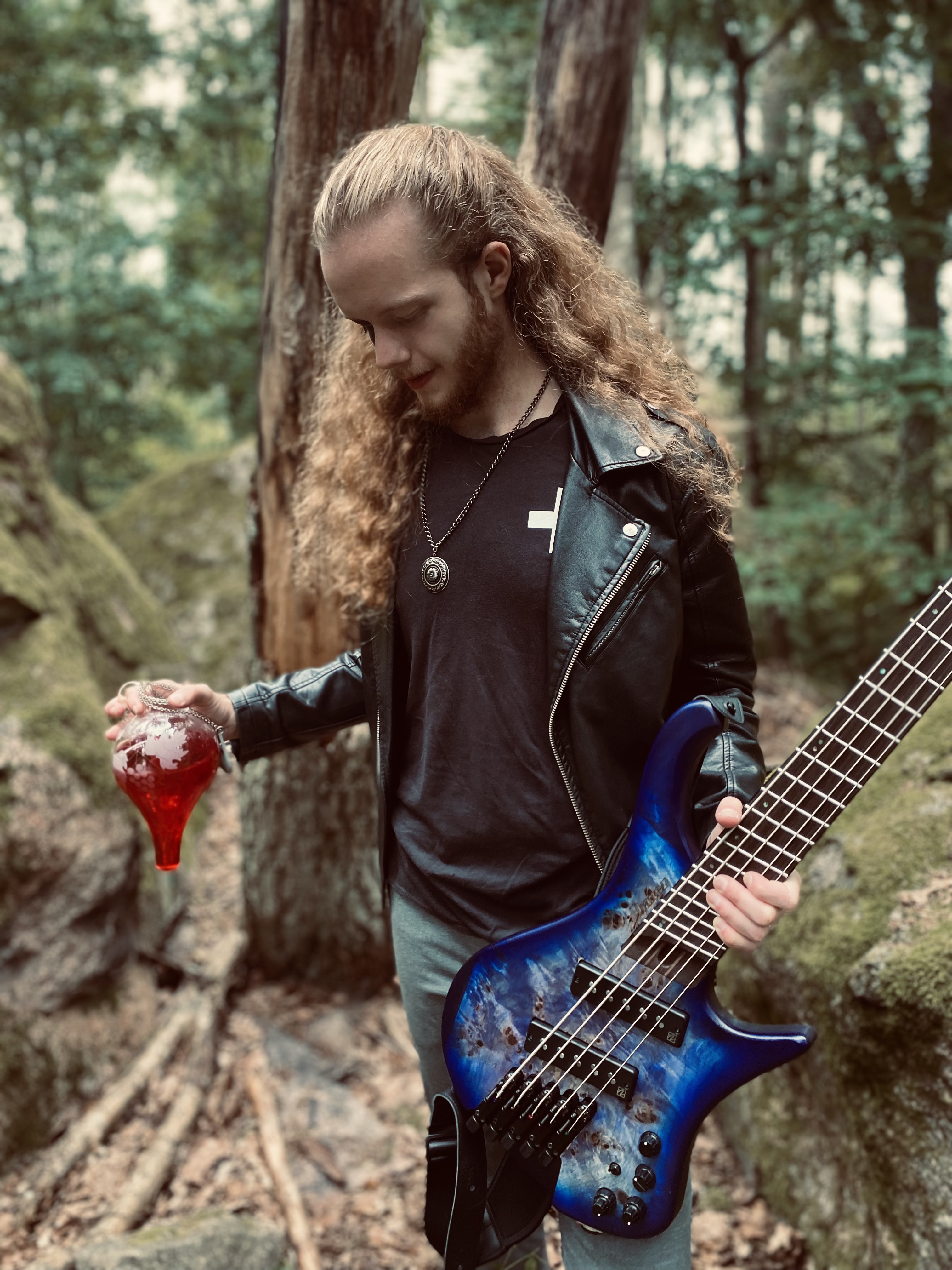 Bassist with a vial of red liquid